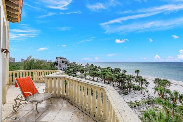 balcony featuring a water view and a view of the beach