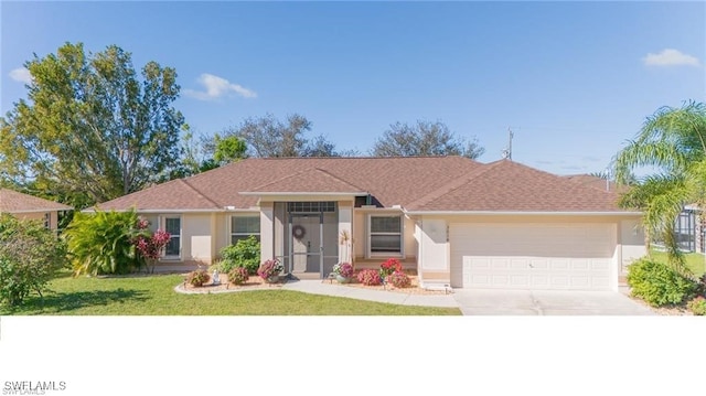 single story home featuring a garage and a front lawn