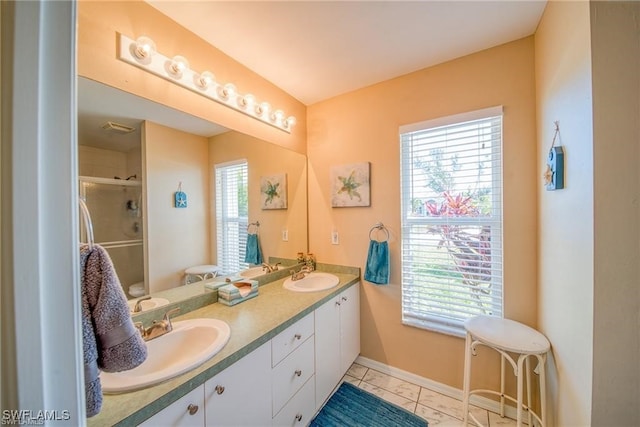 bathroom featuring tile patterned floors, walk in shower, and vanity