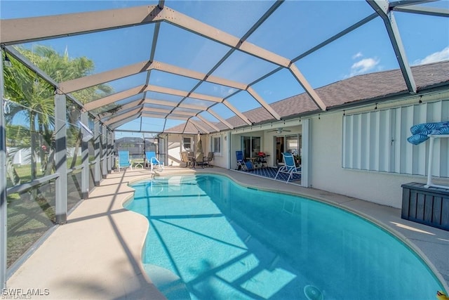 view of pool featuring ceiling fan, glass enclosure, and a patio