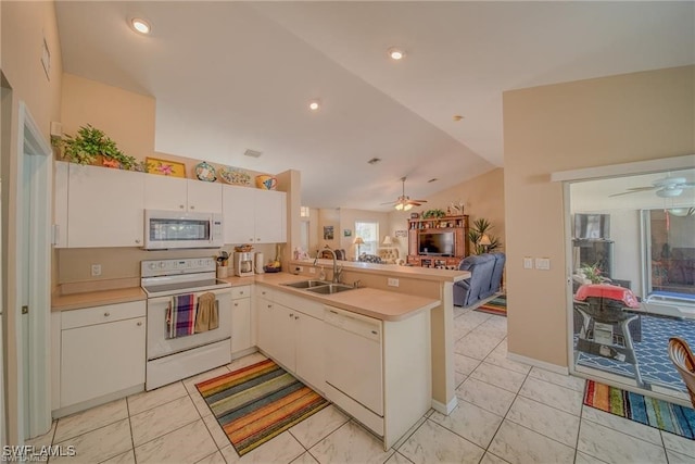 kitchen featuring white cabinets, white appliances, kitchen peninsula, lofted ceiling, and sink