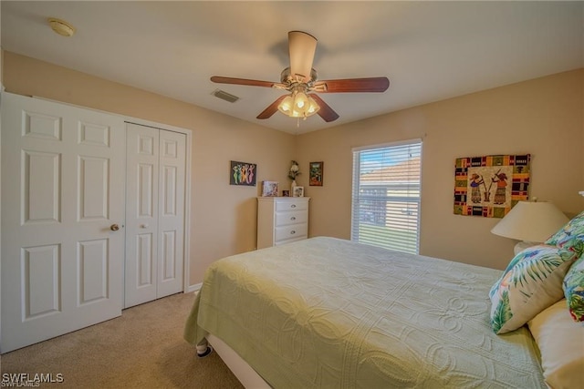 carpeted bedroom featuring ceiling fan and a closet