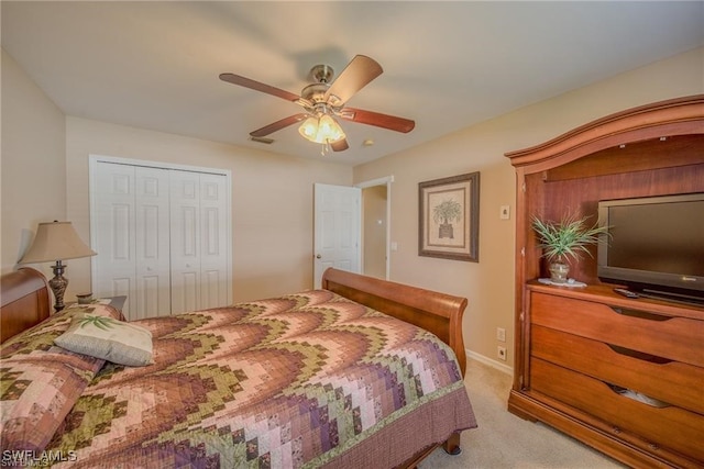 carpeted bedroom featuring ceiling fan and a closet