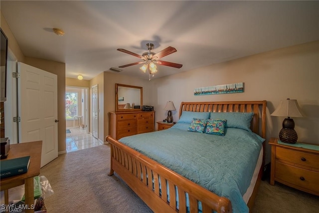 carpeted bedroom featuring connected bathroom and ceiling fan