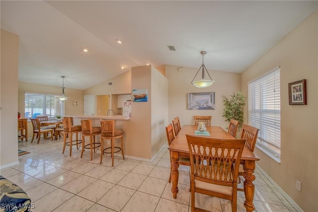 dining area featuring lofted ceiling and a healthy amount of sunlight