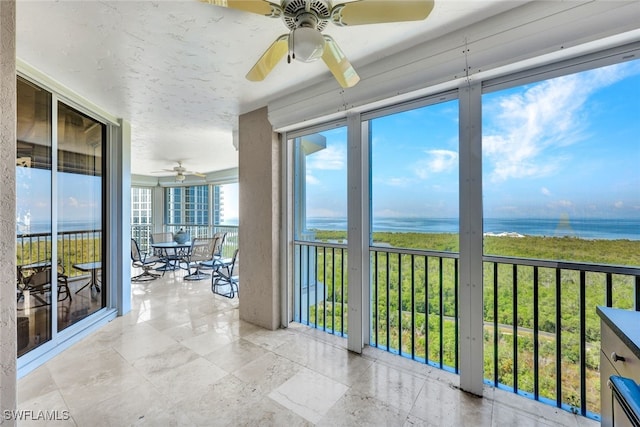 unfurnished sunroom featuring a water view