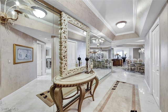 hall with a notable chandelier and crown molding