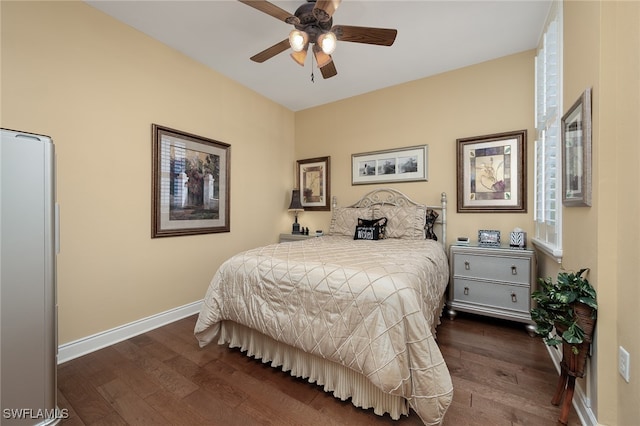 bedroom featuring dark hardwood / wood-style flooring, multiple windows, and ceiling fan