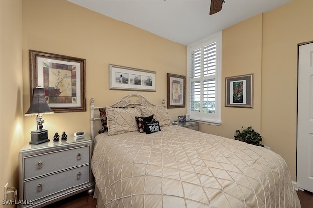 bedroom with ceiling fan and dark hardwood / wood-style floors