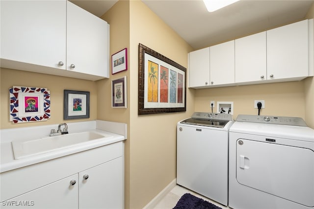 laundry room featuring cabinets, washer and dryer, and sink