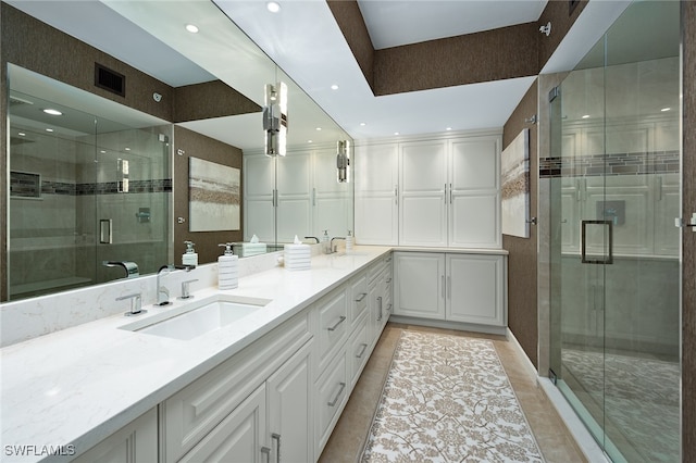 bathroom with vanity, tile patterned floors, and a shower with door