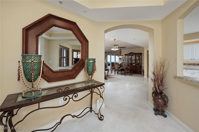 hallway featuring ornamental molding