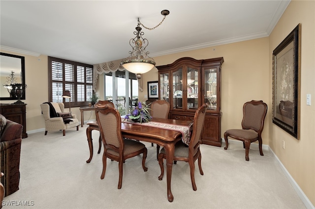 carpeted dining room with crown molding