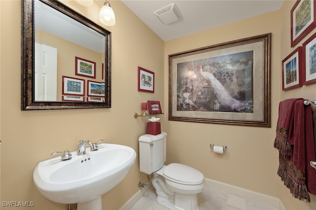 bathroom with tile patterned flooring, sink, and toilet