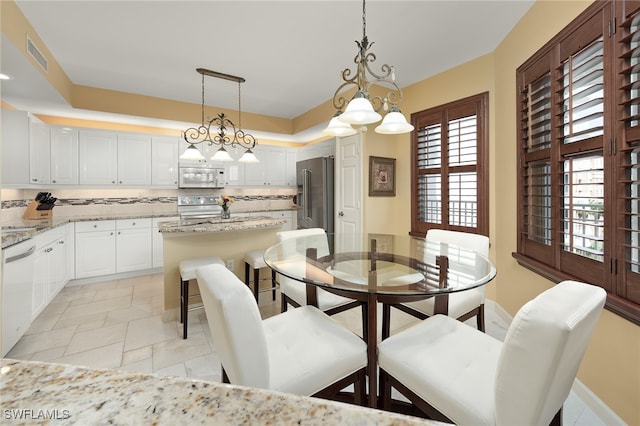 dining space featuring an inviting chandelier