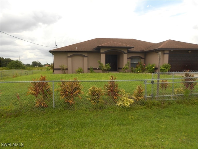 prairie-style home featuring a front yard and a garage