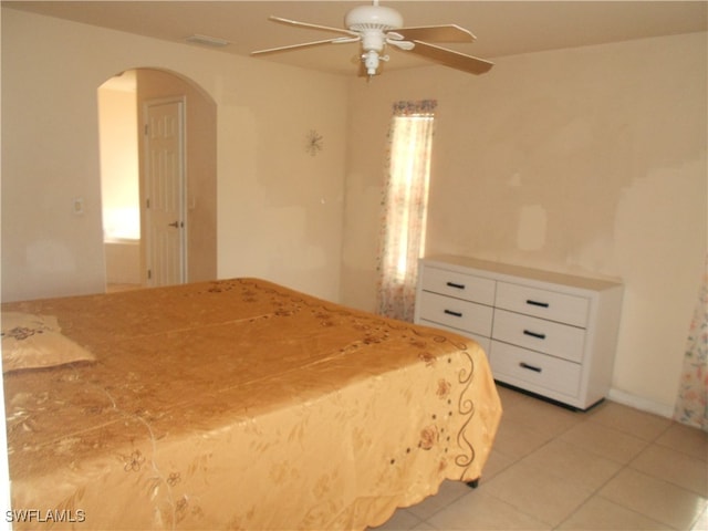 unfurnished bedroom with light tile patterned flooring and ceiling fan