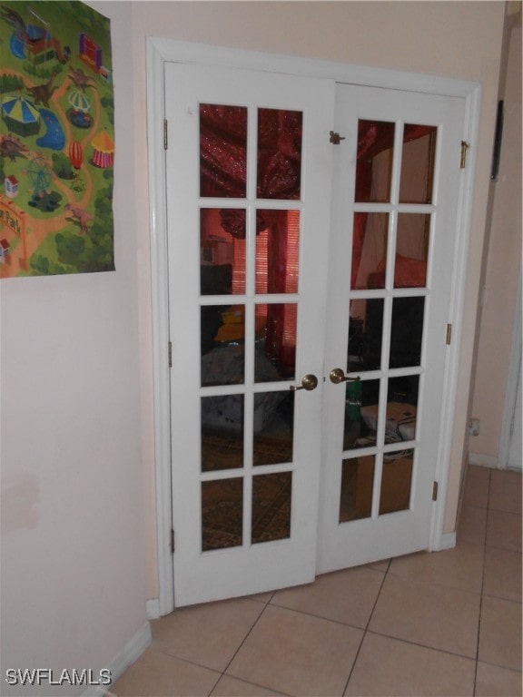 doorway to outside featuring french doors and light tile patterned floors