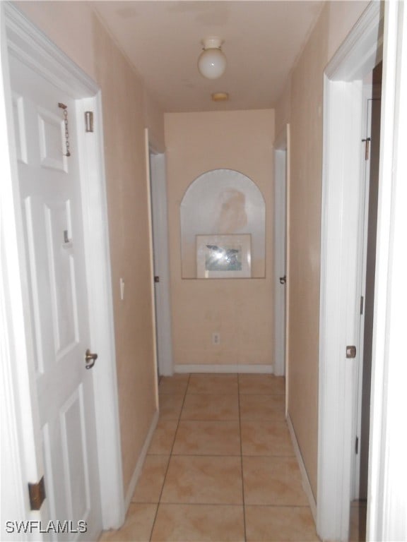 hall with light tile patterned floors