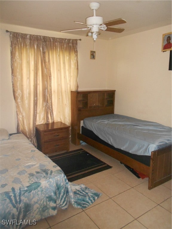 bedroom with ceiling fan and light tile patterned floors