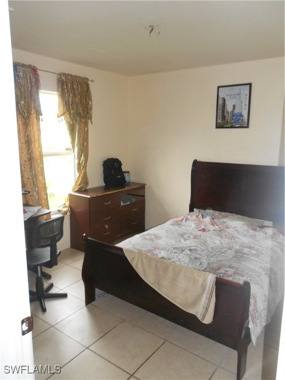 bedroom with light tile patterned floors