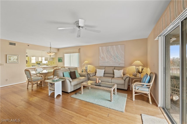 living room with ceiling fan, light hardwood / wood-style flooring, and plenty of natural light