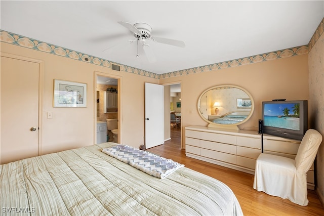 bedroom featuring connected bathroom, light hardwood / wood-style floors, and ceiling fan