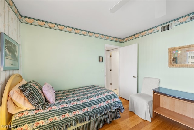 bedroom with hardwood / wood-style floors and ceiling fan