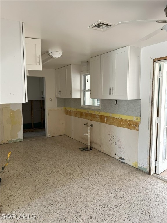 kitchen with white cabinets and ceiling fan