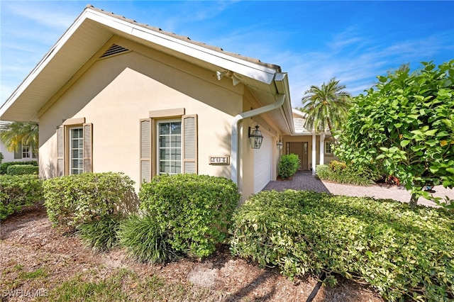 view of property exterior featuring a garage and stucco siding