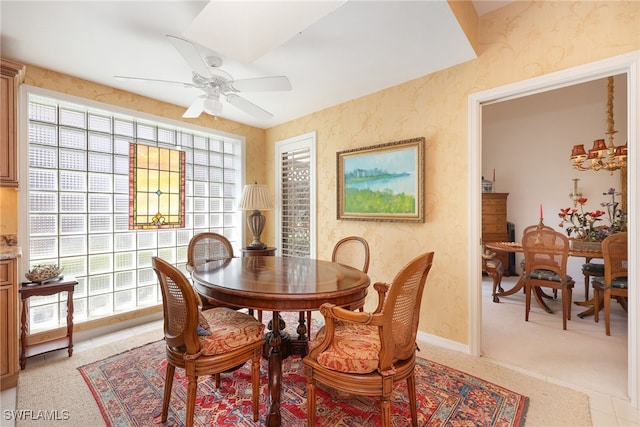 dining space featuring baseboards, a ceiling fan, and wallpapered walls