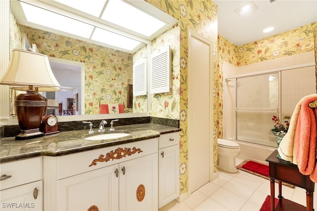 bathroom with vanity, tile patterned floors, combined bath / shower with glass door, and wallpapered walls