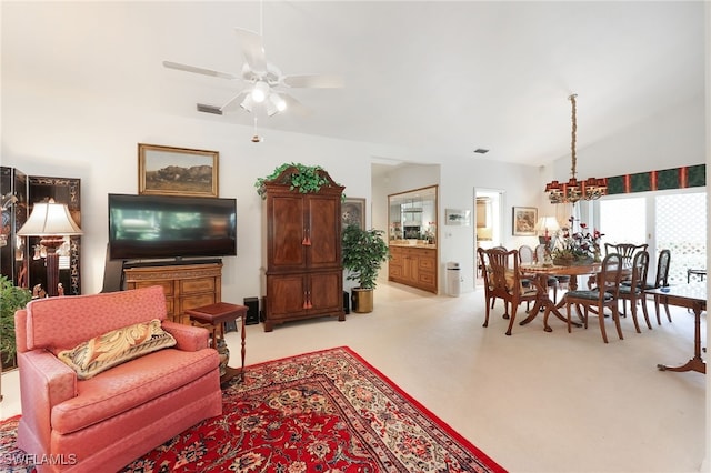 living room featuring visible vents, ceiling fan, light colored carpet, and lofted ceiling
