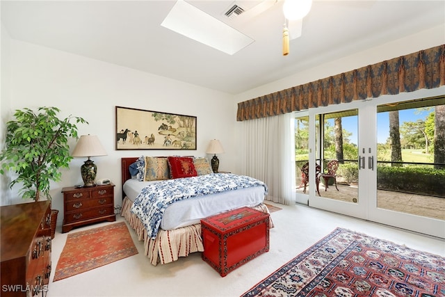 bedroom featuring french doors, access to outside, a skylight, and ceiling fan