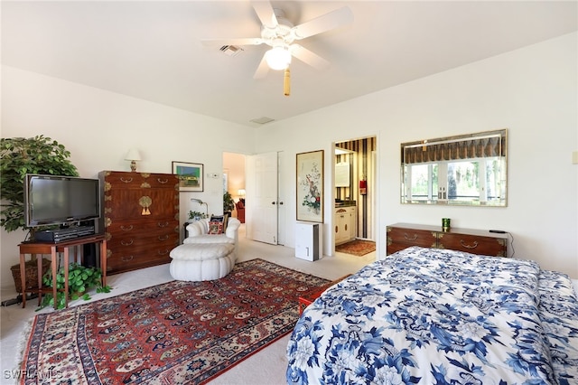 carpeted bedroom featuring ceiling fan and connected bathroom