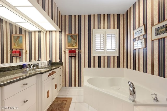 bathroom featuring a relaxing tiled tub, tile patterned flooring, and vanity