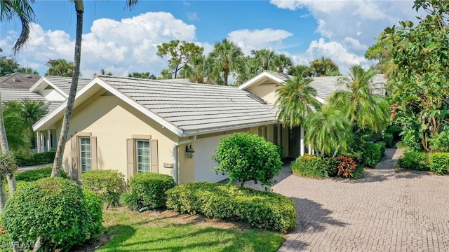 view of front of house with a tiled roof and stucco siding