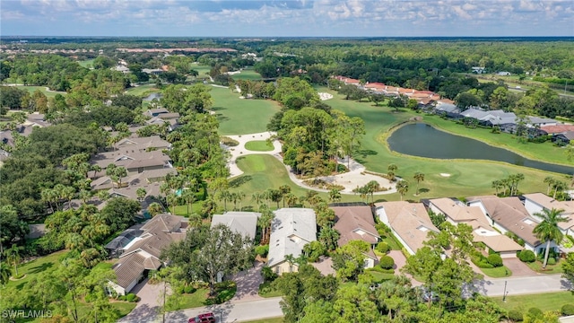 drone / aerial view featuring a water view, golf course view, and a residential view