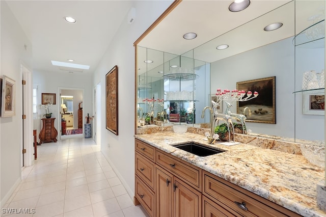 bar with light tile patterned flooring, a sink, baseboards, and recessed lighting