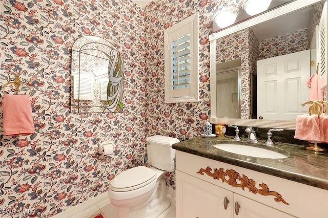 full bathroom featuring a shower stall, vanity, wallpapered walls, and toilet