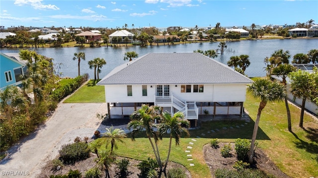 birds eye view of property with a water view