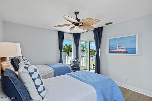 3311 Twin Lakes Ln, Sanibel, FL 33957 - bedroom featuring access to exterior, wood finished floors, and ceiling fan