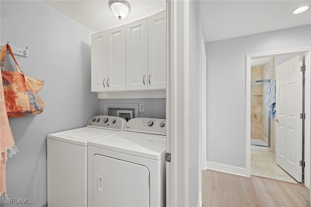 3311 Twin Lakes Ln, Sanibel, FL 33957 - laundry room with cabinet space, washer and clothes dryer, and light wood-style floors