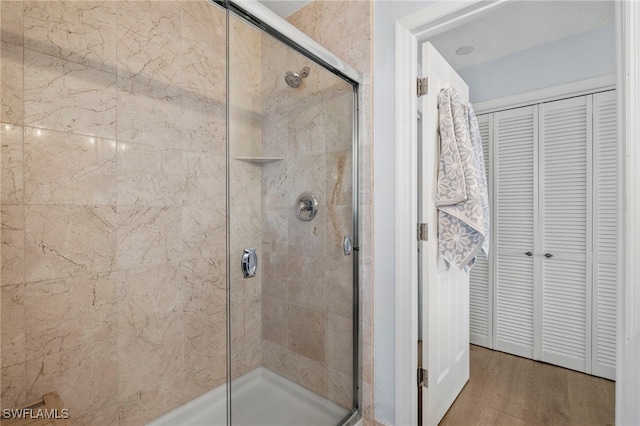 3311 Twin Lakes Ln, Sanibel, FL 33957 - bathroom featuring a closet, a shower stall, and wood finished floors