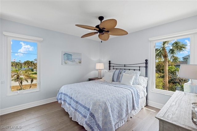 bedroom featuring light wood-type flooring and multiple windows