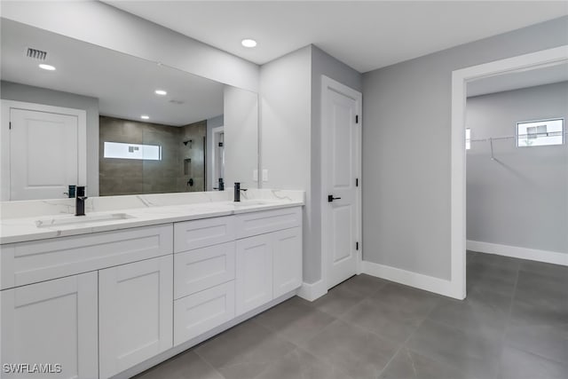 bathroom featuring walk in shower and vanity