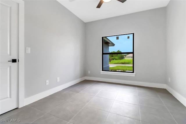 spare room featuring ceiling fan and light tile patterned floors