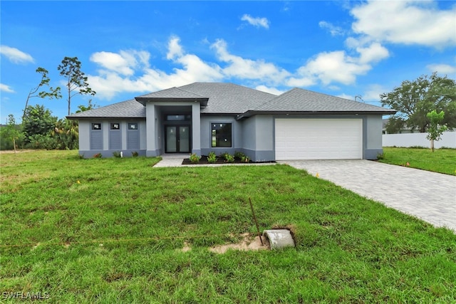 view of front of home with a garage and a front yard