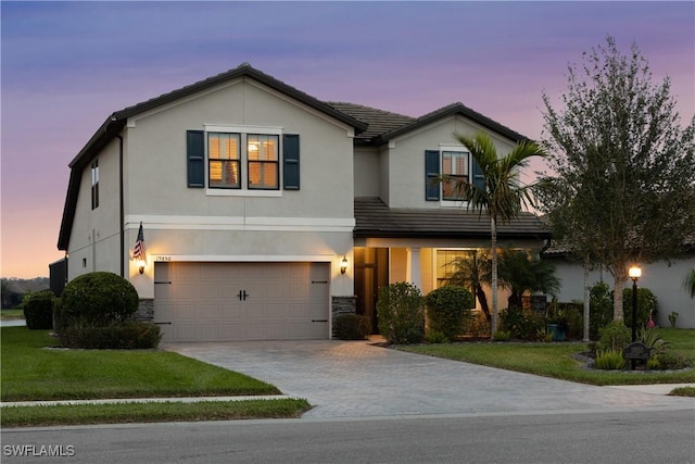 view of front of house featuring a garage and a yard