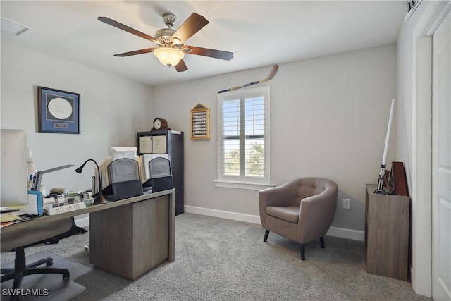 carpeted home office featuring ceiling fan